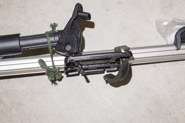 Photograph of Thule ProRide 591 roof top bike carrier, showing pivoting bolt and cross bar clamp assembly.